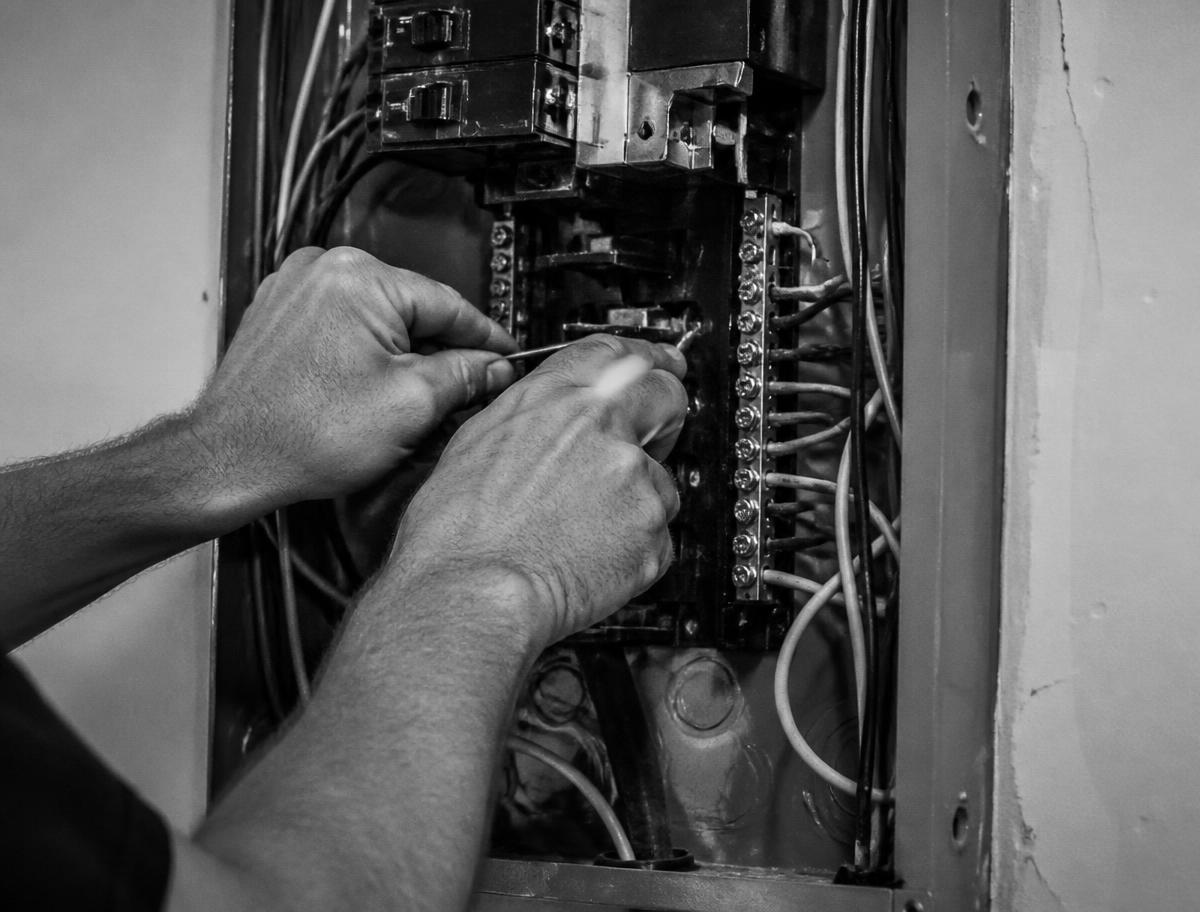Electrician wiring a residential breaker panel